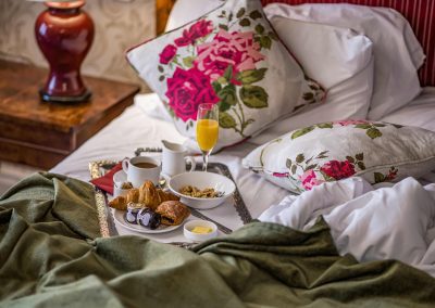 Messy bed with breakfast at the speech house